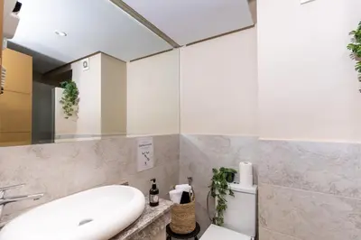 a bathroom with a white sink and a toilet at Lalla Homes 369 in Marrakech