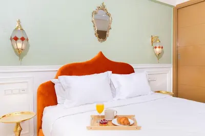 a hotel room with a bed with a tray of food on it at Lalla Homes 369 in Marrakech