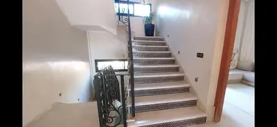 a spiral staircase in a room with a stair railing at Atlantic Villa in Marrakech
