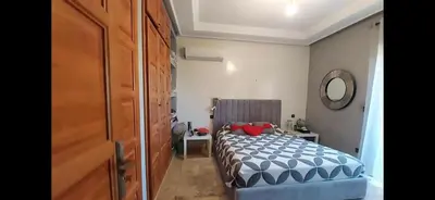 a small bedroom with a bed and a mirror at Atlantic Villa in Marrakech