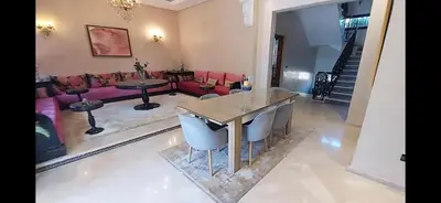 a living room with a table and a couch at Atlantic Villa in Marrakech