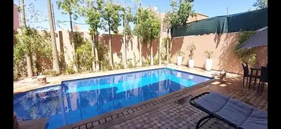 a swimming pool in a backyard with a fence at Atlantic Villa in Marrakech