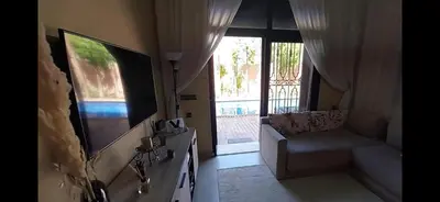 a living room with a couch and a flat screen tv at Atlantic Villa in Marrakech