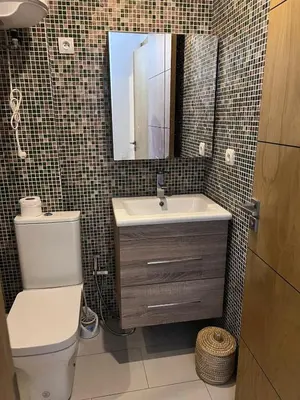 a bathroom with a toilet and a sink and a mirror at Modern quiet studio Close to Guéliz in Marrakech