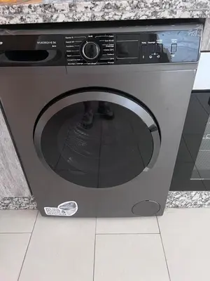 a washing machine with its door open in a kitchen at Modern quiet studio Close to Guéliz in Marrakech