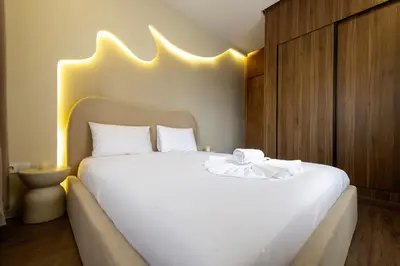 a bedroom with a large white bed with lights on it at Exceptional Apartment Overlooking Marrakech Train Station in Marrakech