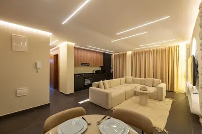 a living room with a couch and a table at Exceptional Apartment Overlooking Marrakech Train Station in Marrakech