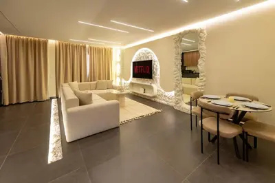 a living room with a white couch and a table at Exceptional Apartment Overlooking Marrakech Train Station in Marrakech