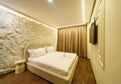 a small room with a bed and a television at Exceptional Apartment Overlooking Marrakech Train Station in Marrakech