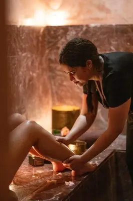 a woman is preparing food in a kitchen at Almaha Marrakech Restaurant & SPA in Marrakech