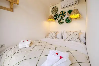 a bedroom with a bed with towels on it at Kasbah Djellaba pool breakfast city center in Marrakech