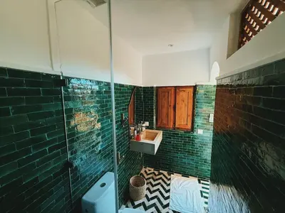 a bathroom with a glass shower and a sink at Kasbah Djellaba pool breakfast city center in Marrakech