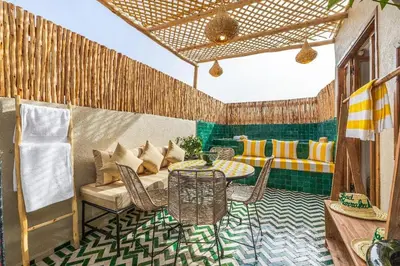 a patio with a table and chairs in a room at Kasbah Djellaba pool breakfast city center in Marrakech