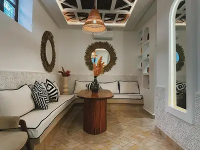 a living room with a couch and a table at Kasbah Djellaba pool breakfast city center in Marrakech