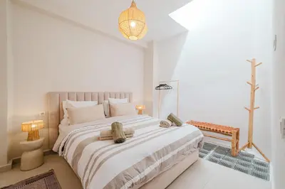 a white bedroom with a large bed in a room at 3BR Gueliz , Rooftop Heated Pool , 10 min Jamaa el Fna, in Marrakech
