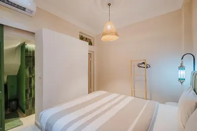 a bedroom with a bed and a pendant light at 3BR Gueliz , Rooftop Heated Pool , 10 min Jamaa el Fna, in Marrakech