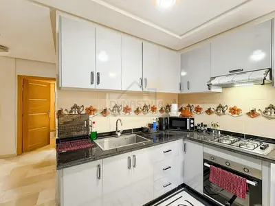 a kitchen with white cabinets and a sink at Séjour chic au cœur de Marrakech in Marrakech