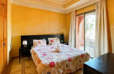 a bedroom with a bed and a large window at Evasion élégante à la Palmeraie in Marrakech