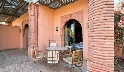 an outdoor patio with a table and chairs at Evasion élégante à la Palmeraie in Marrakech