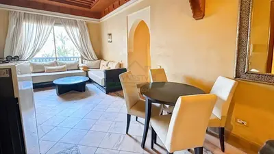 a living room with a table and a couch at Evasion élégante à la Palmeraie in Marrakech