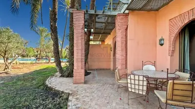 an outdoor patio with a table and chairs at Evasion élégante à la Palmeraie in Marrakech