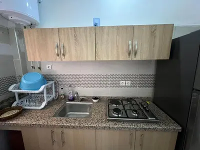 a kitchen counter with a sink and a stove at Modern Apartment & 8 min from Marrakech Airport in Marrakech