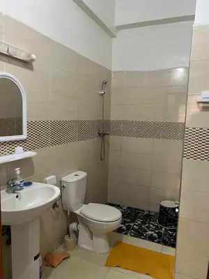 a bathroom with a toilet and a sink and a shower at Modern Apartment & 8 min from Marrakech Airport in Marrakech