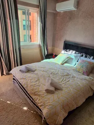 a bedroom with a large bed with towels on it at Appartement centre ville Gueliz in Marrakech