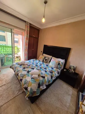 a bedroom with a bed with a colorful comforter at Appartement centre ville Gueliz in Marrakech