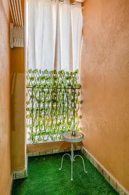 a table in front of a window with a plant at Studio élégant et paisible au cœur de Marrakech in Marrakech