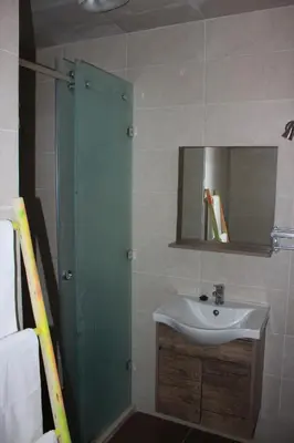 a bathroom with a sink and a shower with a mirror at Riad R Art in Marrakech