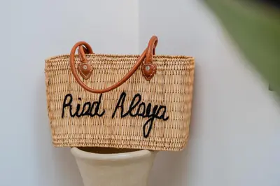 a rattan basket bag with the words fixed a bike at Riad Alaya in Marrakech
