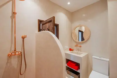 a bathroom with a sink and a toilet and a mirror at Riad Alaya in Marrakech