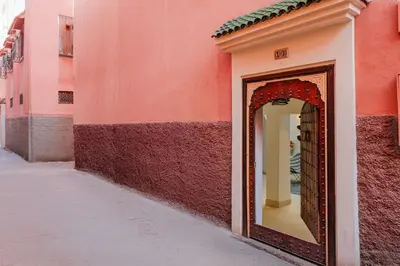 a mirror on the side of a pink building at Riad Alaya in Marrakech