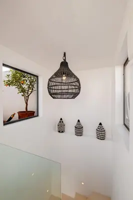 a room with white walls and a pendant light at Riad Alaya in Marrakech