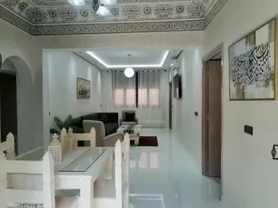 a living room with a couch and a table at HU Aappartement in Marrakech