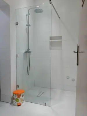 a shower with a glass door in a bathroom at HU Aappartement in Marrakech