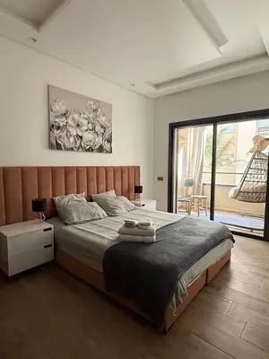 a bedroom with a large bed and a large window at Luxury 2-room apartment - Pool view in Marrakech