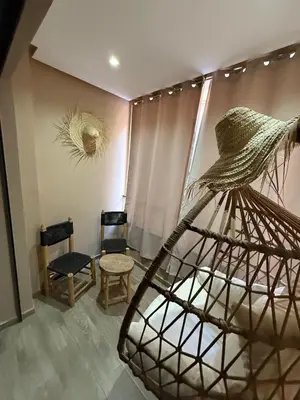 a room with a chair and a table and a sculpture at Luxury 2-room apartment - Pool view in Marrakech