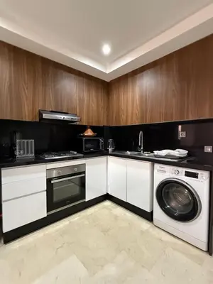 a kitchen with a washer and a dishwasher at Luxury 2-room apartment - Pool view in Marrakech
