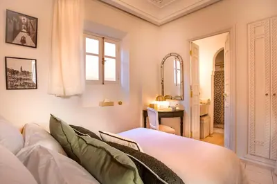 a living room with a white couch and a window at Riad Anaqa in Marrakech