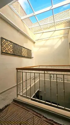 a large room with a skylight and a staircase at Douiria des Loulous in Marrakech