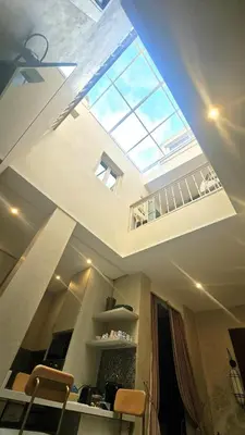 a skylight in the ceiling of a living room with a staircase at Douiria des Loulous in Marrakech