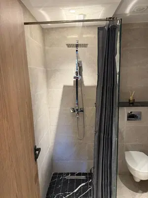 a bathroom with a shower and a toilet at Appartement Haut standing Gueliz, Piscines, jacuzzi chauffé & Fitness in Marrakech