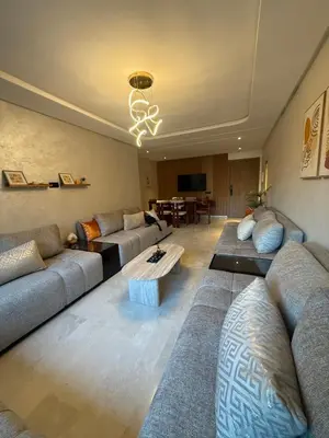 a living room with couches and a coffee table at Appartement Haut standing Gueliz, Piscines, jacuzzi chauffé & Fitness in Marrakech
