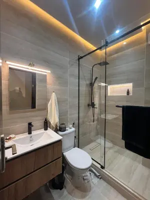 a bathroom with a toilet and a sink and a shower at Chic apartment in a secure residence in Marrakech