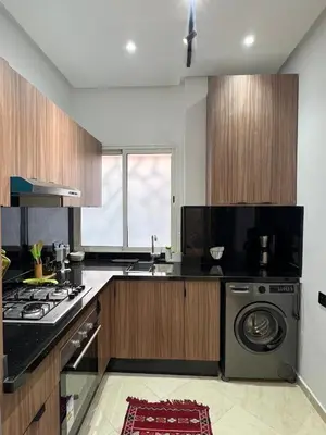 a kitchen with a washer and dryer in it at Chic apartment in a secure residence in Marrakech
