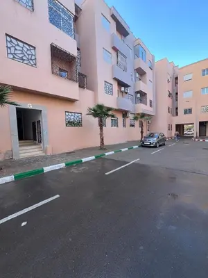 a car parked in a parking lot next to a building at Chic apartment in a secure residence in Marrakech