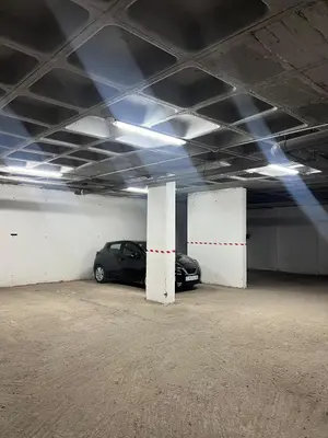 a parking garage with a car parked in it at Chic apartment in a secure residence in Marrakech