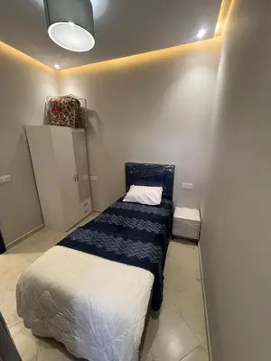 a small bedroom with a bed in the corner at Chic apartment in a secure residence in Marrakech